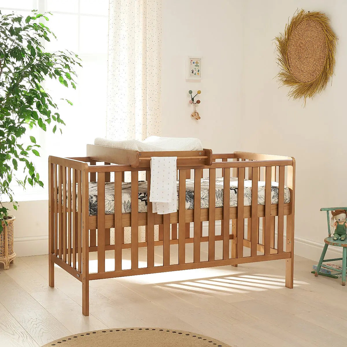 Scandinavian style wooden crib in a bedroom